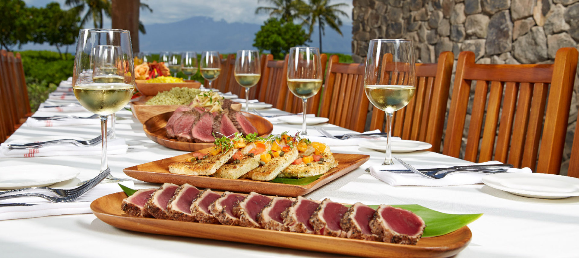 Large set table feast with multiple dishes and wine glasses