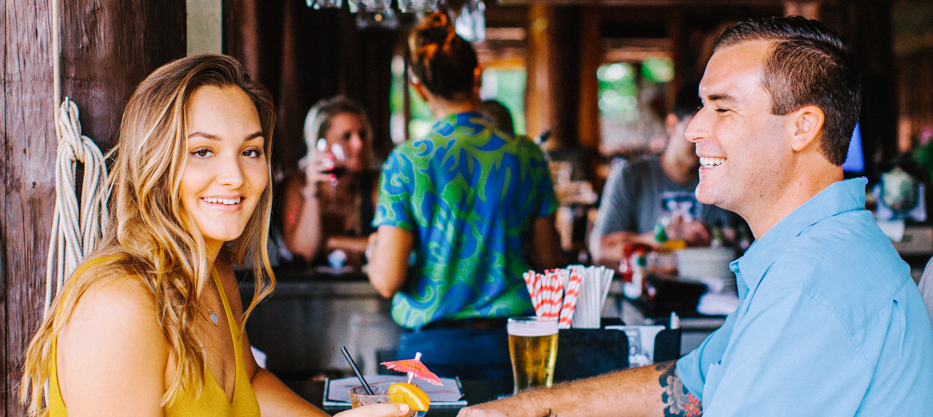 Man and woman sharing drinks together at a bar