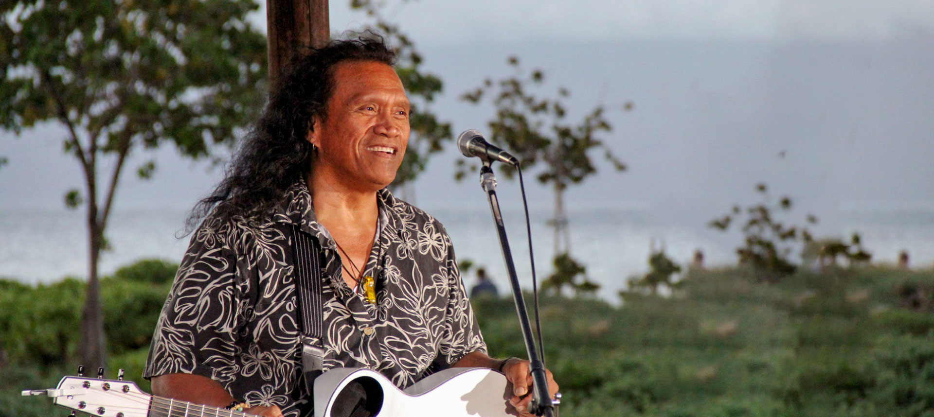 Henry kapono preforming by the beach