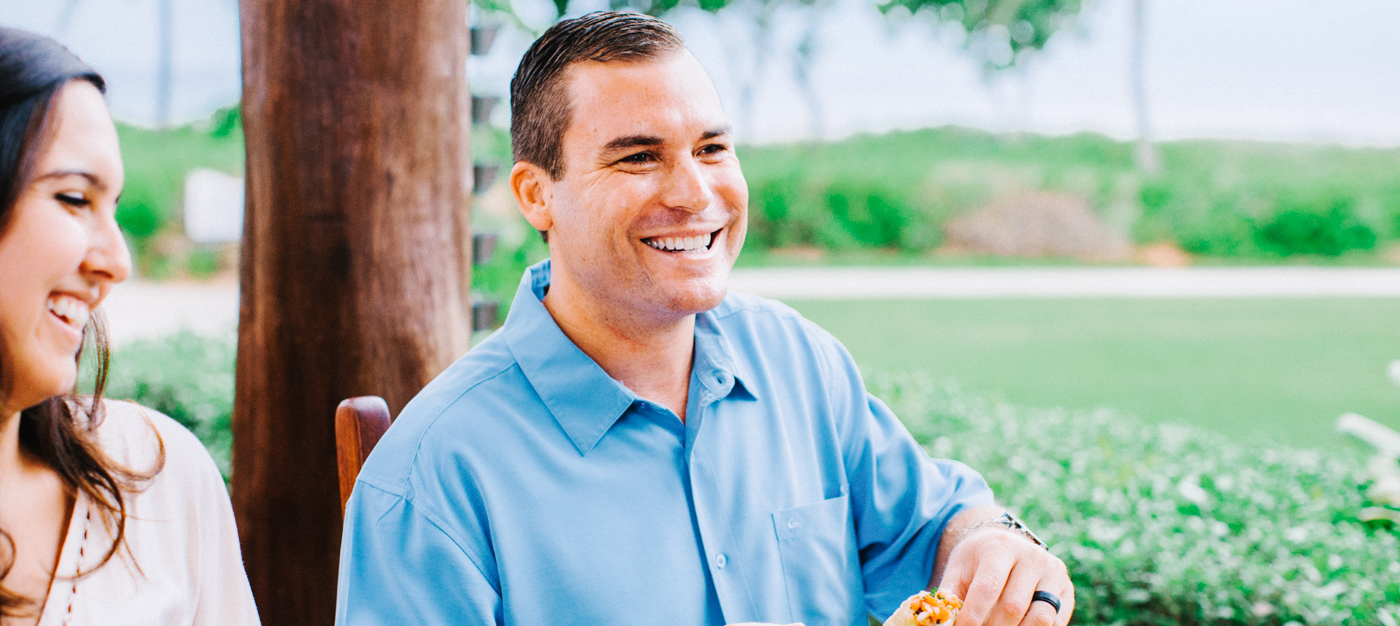 Woman and man smiling while eating dinner