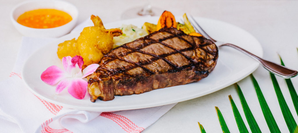 Large steak with fried shrimp and vegetables