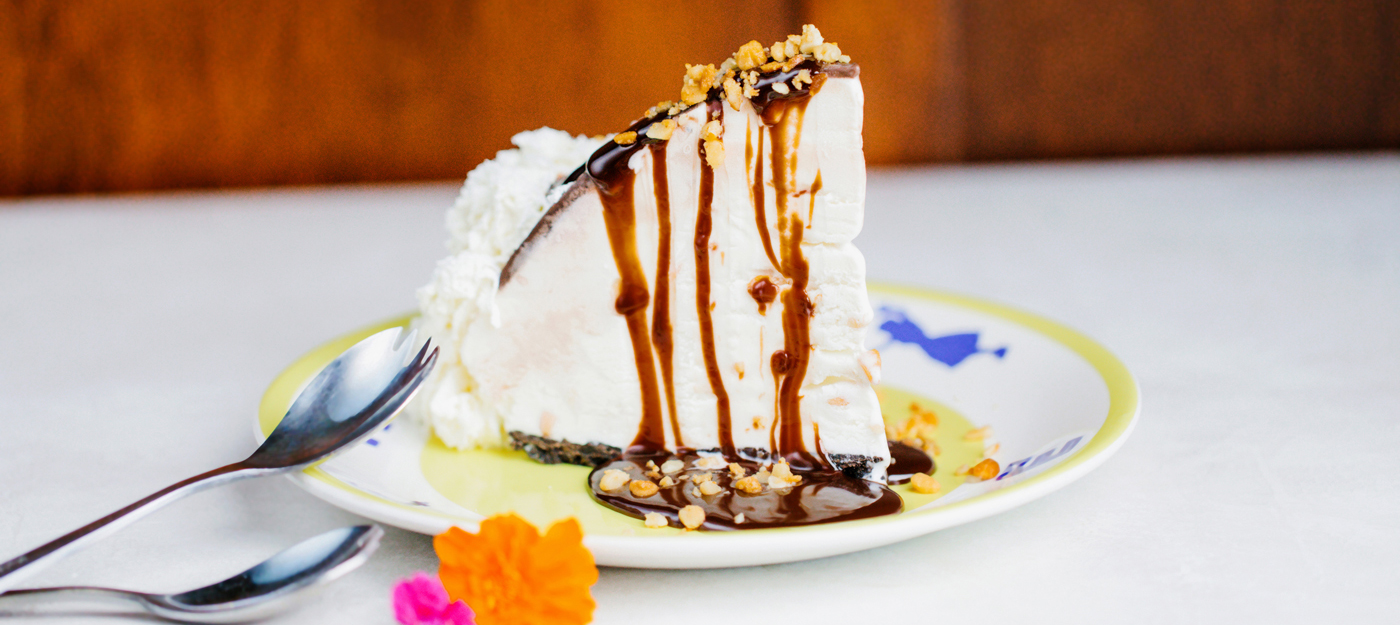 Vanilla cream cake with fudge and nuts