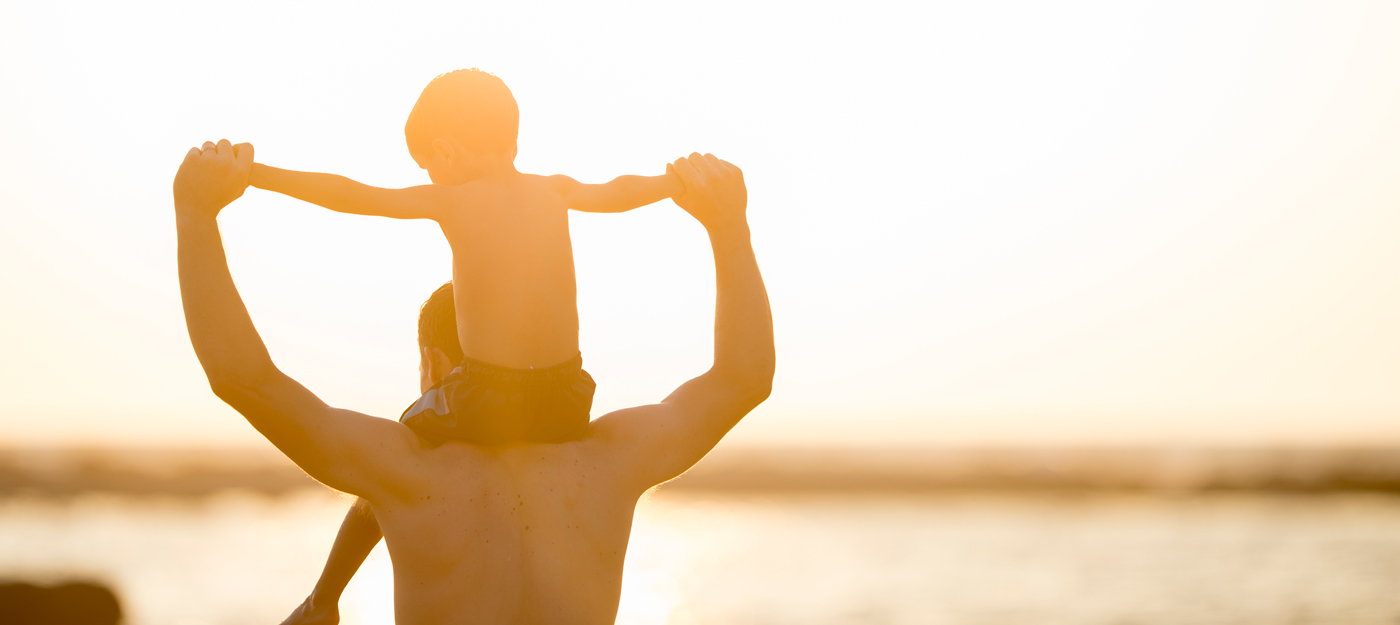 Father with son on shoulders at the beach